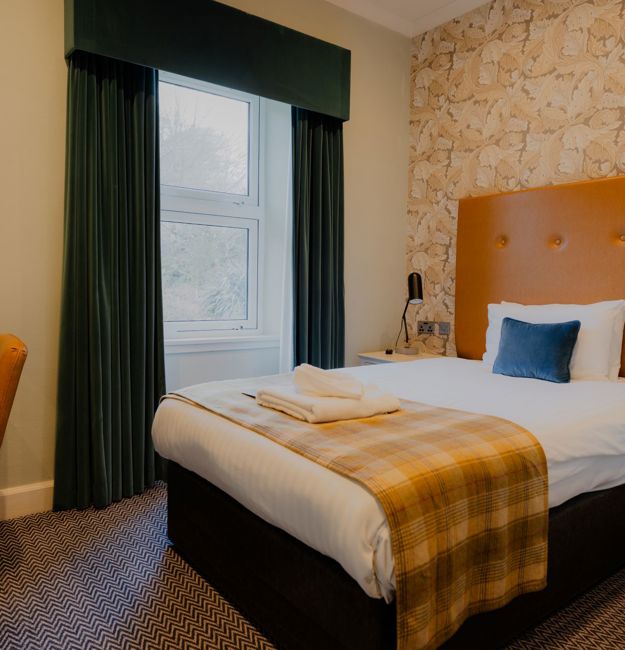Queen bed in single room at Ballachulish Hotel